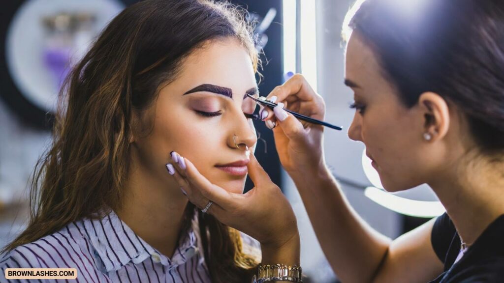 A designer working on client's eyelashes and eyebrows