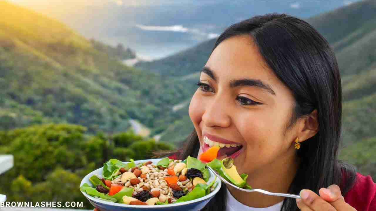 A woman eating a salad filled with nuts and seeds, illustrating a diet beneficial for eyelash health