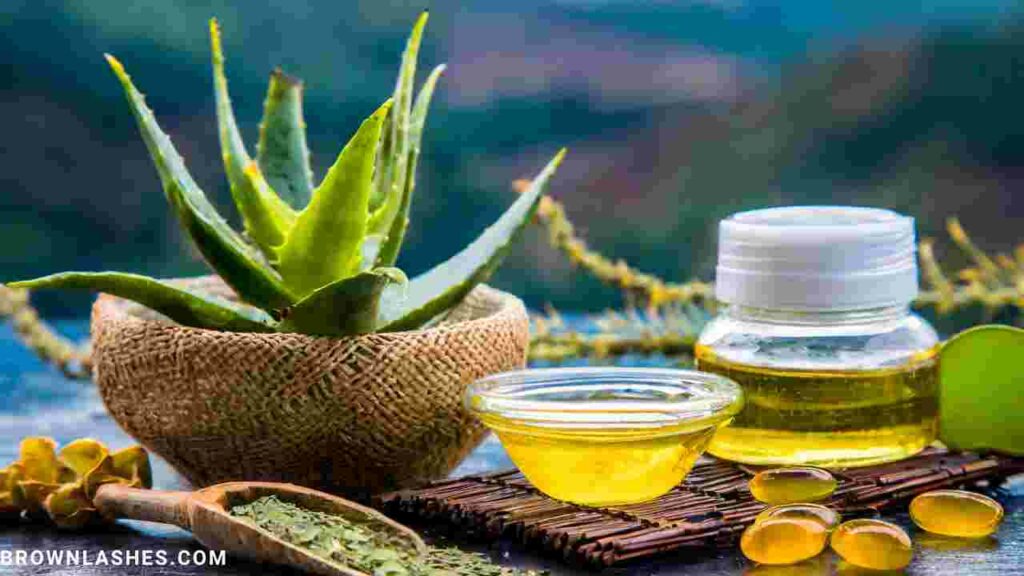 Aloe vera gel, bottle of argan oil , cup of green tea , jojoba oil, in a transparent container, showcasing its soothing and moisturizing properties for eyelashes.