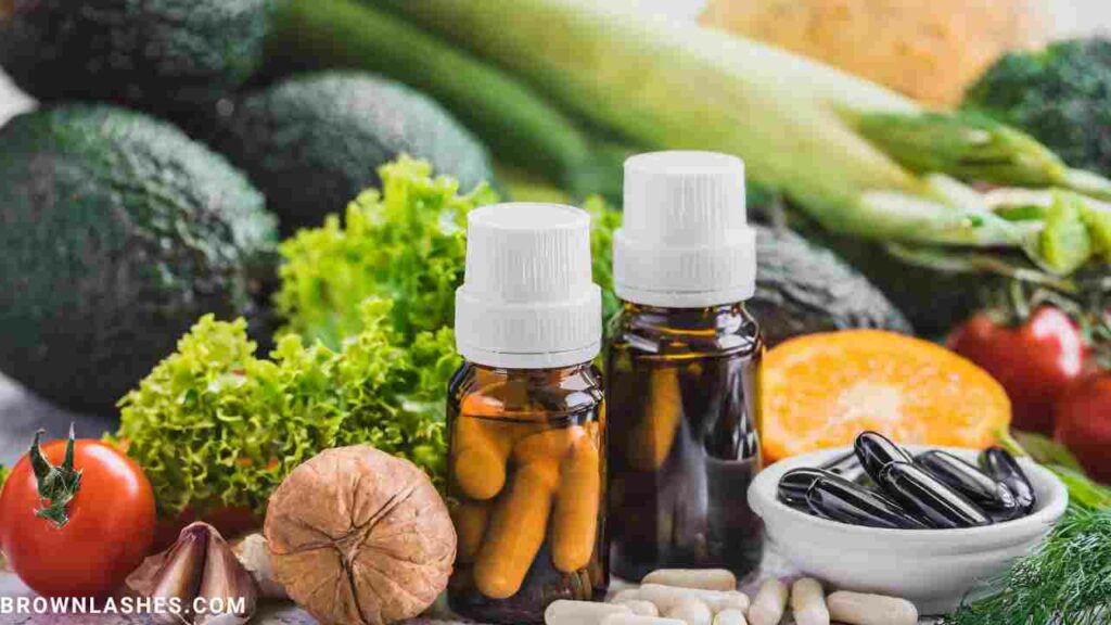 Bottles of vitamins and supplements next to fresh produce, symbolizing the importance of nutrients for lashes